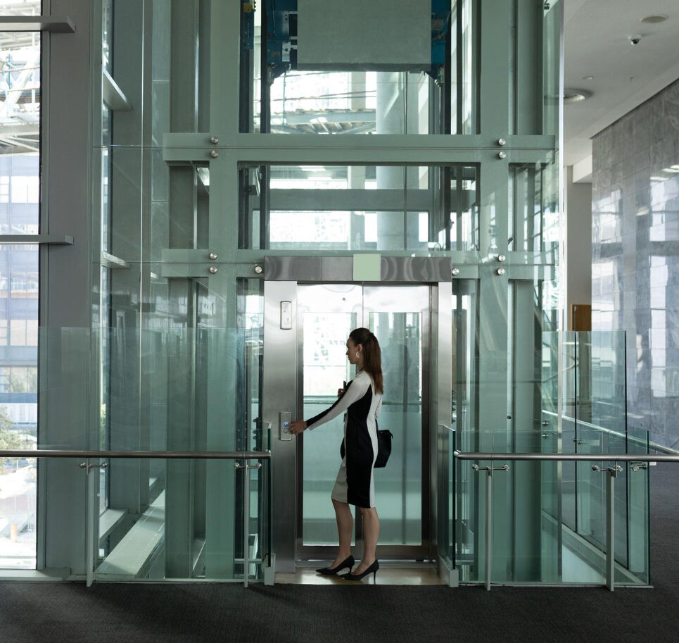 A woman enters a clean scenic glass lift
