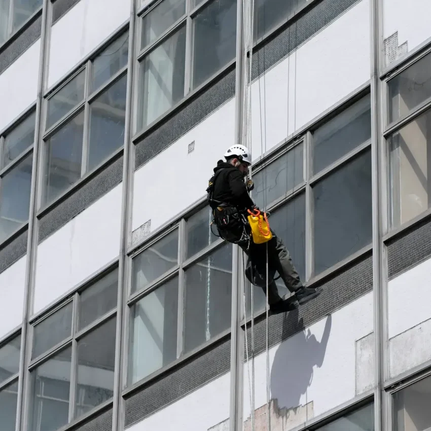 An Abseiler Window Cleaner cleaning the exterior of a building
