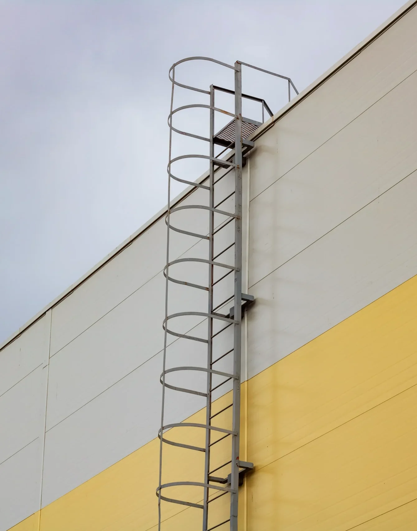 Ladder roof tall building dark sky background