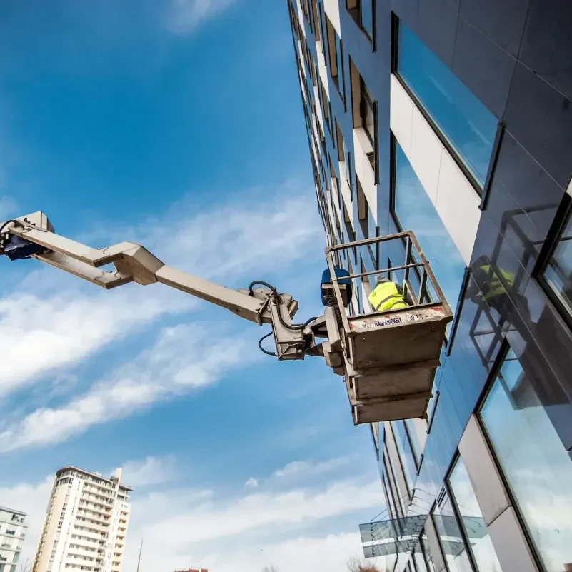 Window Cleaners using a MEWPS to access and clean high windows on a hotel facade