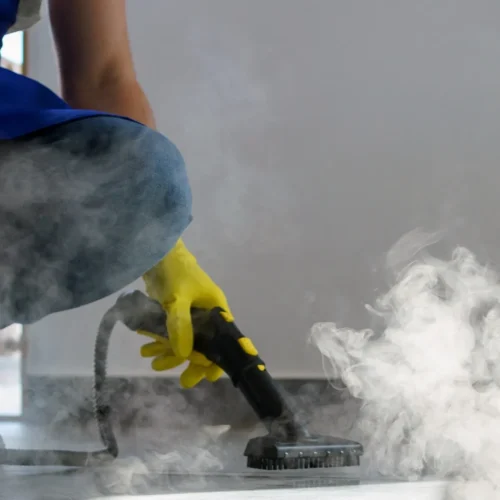 Steam-cleaning hotel corridor carpet using hot-water extraction equipment