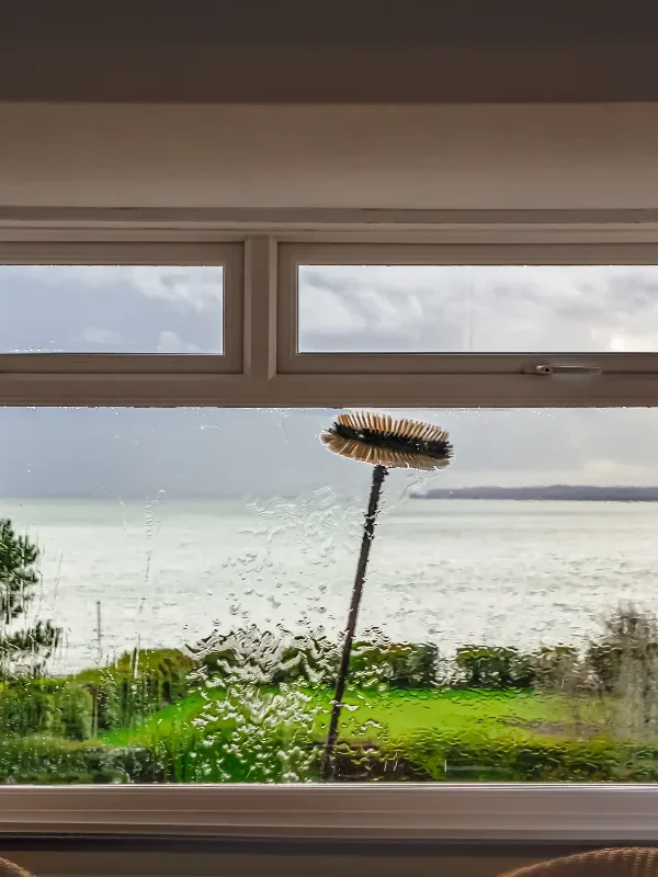 A pure-water window cleaning pole system brushing and rinsing windows